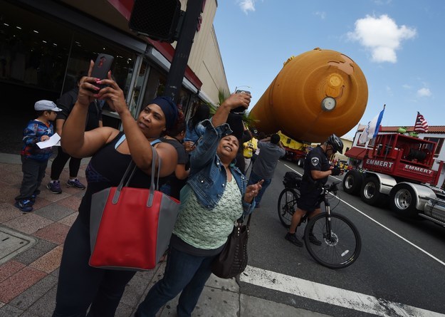 The 15-story fuel tank that is to be attached to Space Shuttle Endeavour wound its way — very slowly — through the crowded streets of Los Angeles, drawing fans and curious onlookers to marvel at the massive tank of space history.