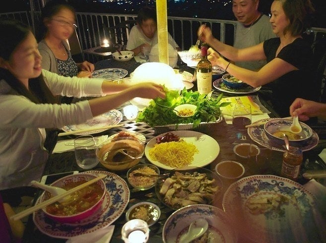 My cousins working on a feast of bún riêu, bò bía, and other Viet dishes at home.