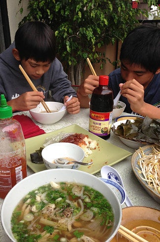 My younger brothers, Nathan and Nicholas, eating phố.