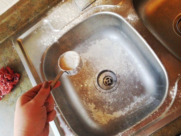 Wash your sink out like a dish (using hot water and dish soap), then polish it with flour.