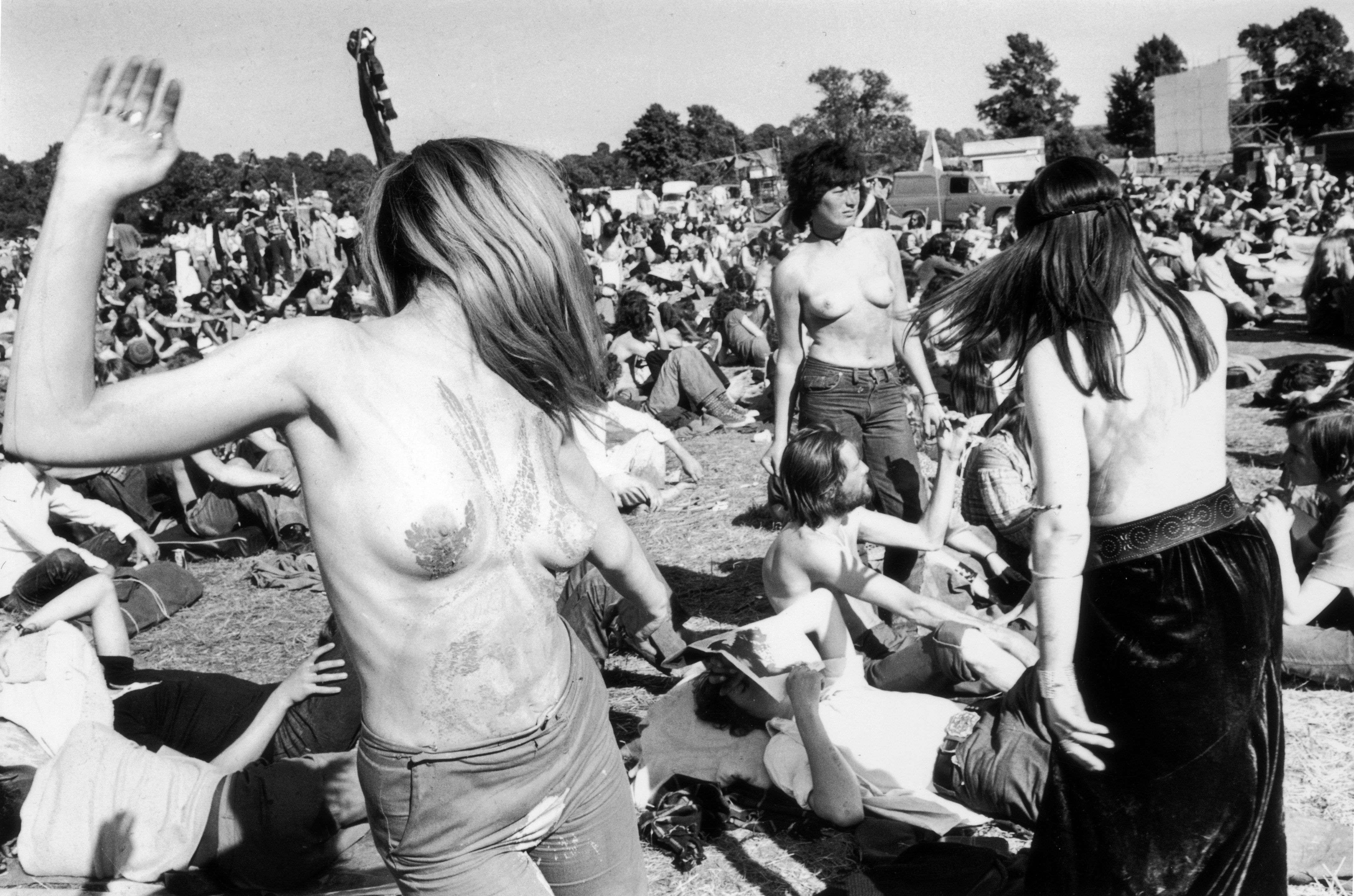 Topless hippies enjoying the sunshine at the second Glastonbury fair