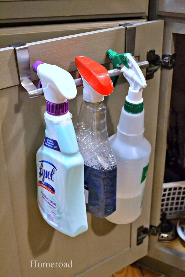 Keep your spray cleaners close at hand by hanging them over an over-the-cabinet towel holder.