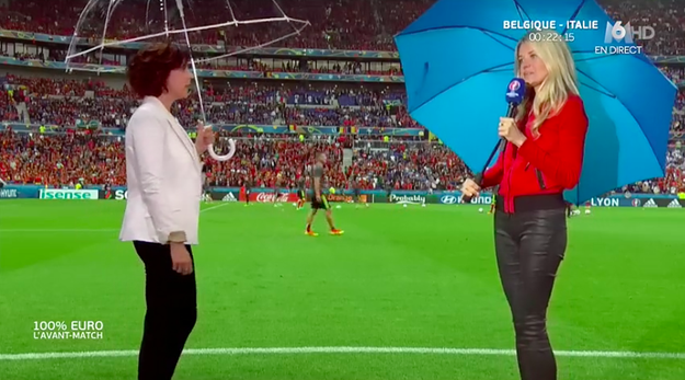 It gets even weirder when both of them are holding umbrellas because it's raining at the stadium.