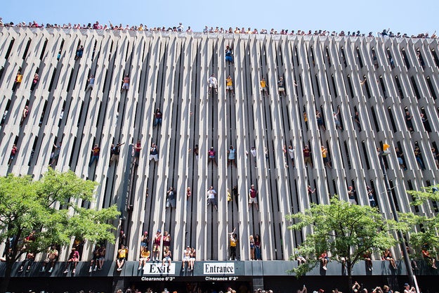 Near the beginning of the route, some Cavaliers fans were so eager to catch a glimpse of their team they scaled the outside wall of a parking garage.