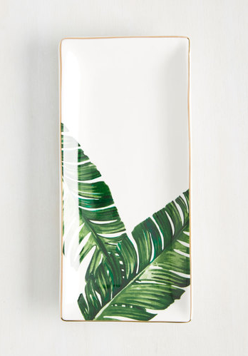 This jewelry tray that's painted with palm leaves.