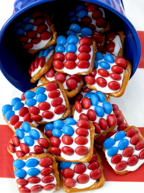 red and blue M&amp;amp;M&#x27;s on white candy melted onto pretzels