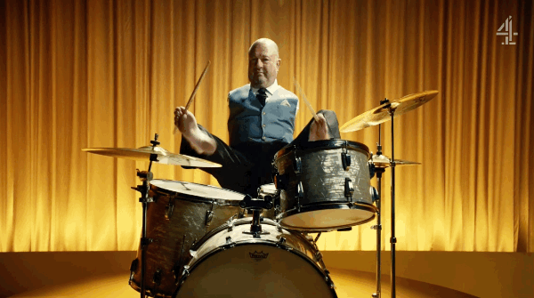 That's Alvin Law, the drummer in the band. In a promotional video for Channel 4, he explains the meaning of the video: "It's so weird that this video is called "Yes We Can" because it was my mantra in our home growing up. My mum and dad said 'till I was tired of it, there is no such word as can't."