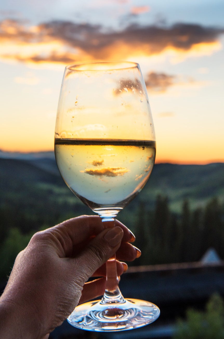 A treelined sunset through a glass of prosecco from the observatory tower.