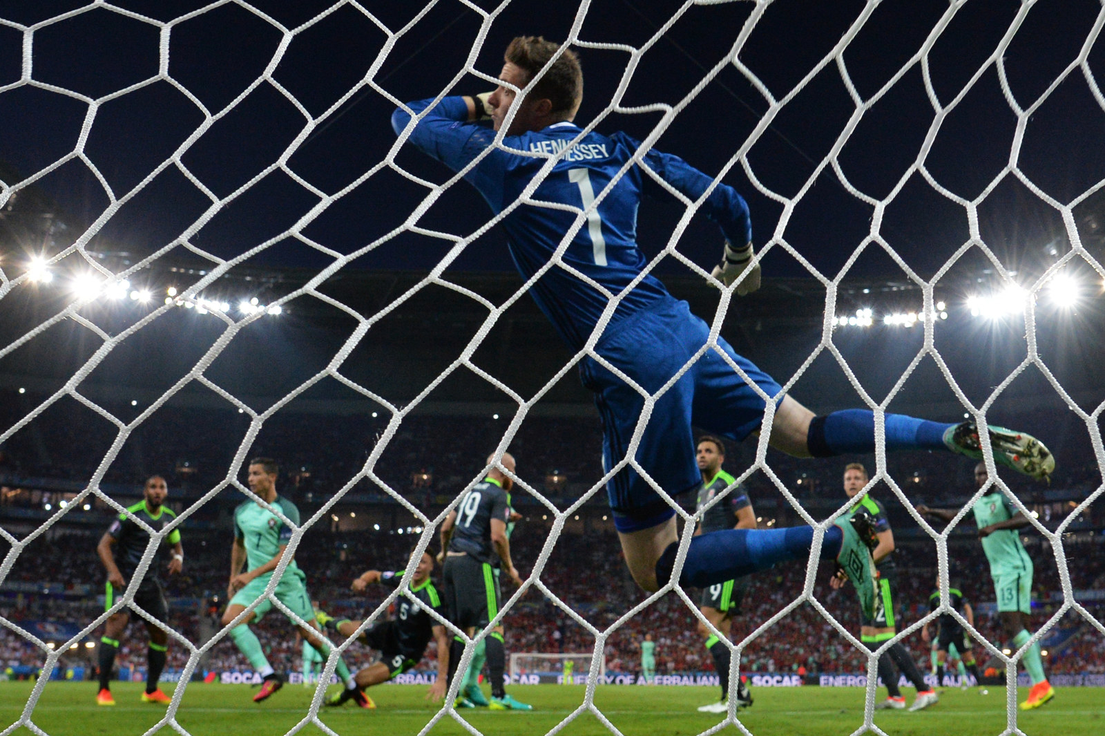 Cristiano Ronaldo scores against Wales' goalkeeper Wayne Hennessey.