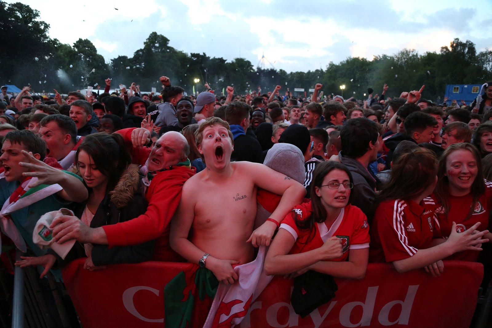 Wales fans in Cardiff celebrate after Wales score their second goal to take the lead against Belgium.