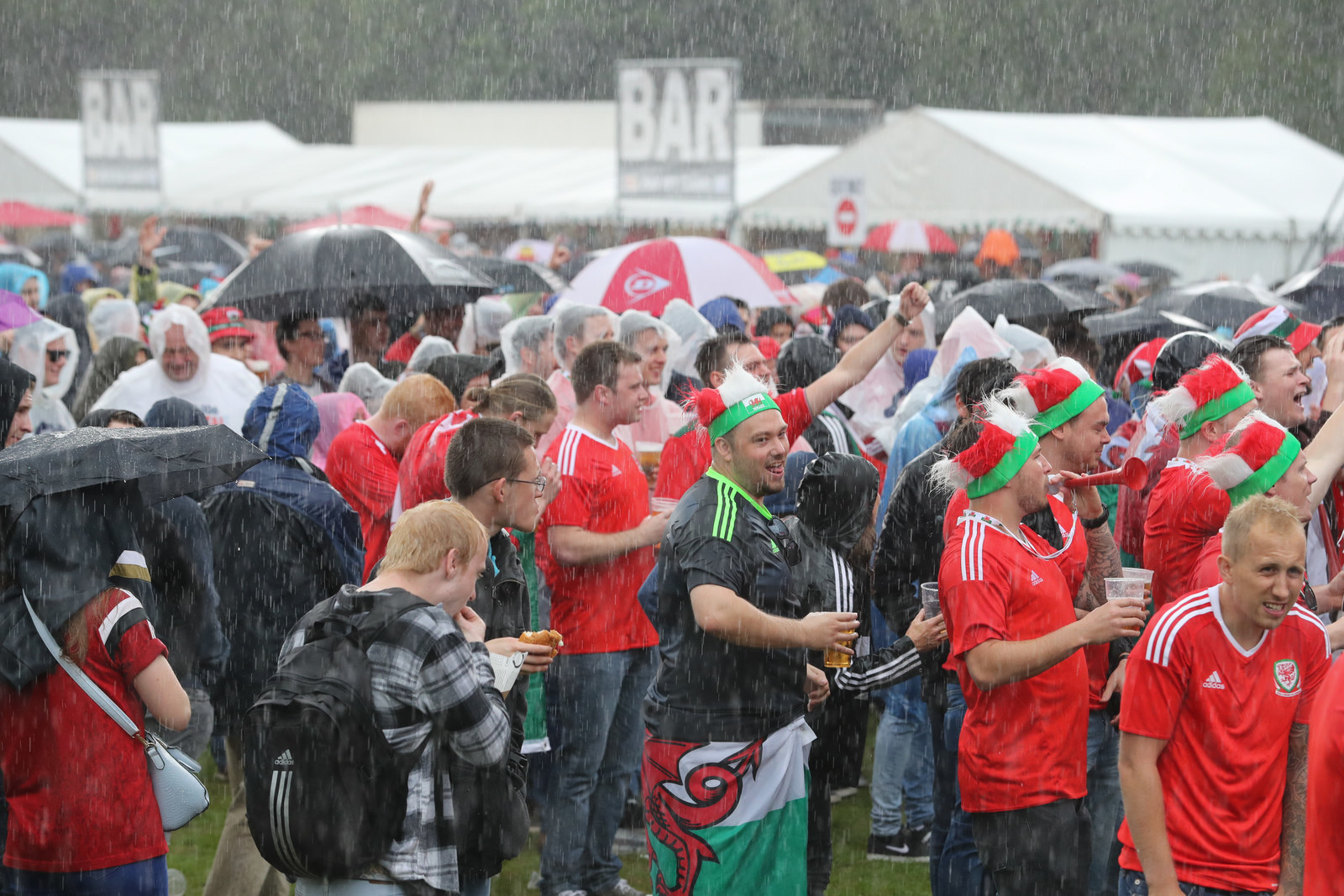 Back in Cardiff, fans brave the rain to watch Wales take on England.