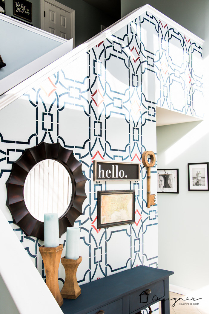 entryway with light blue background and dark blue geometric stencil pattern