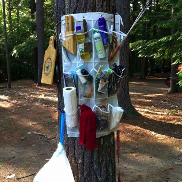Tie a shoe rack around a tree to hold all your stuff.