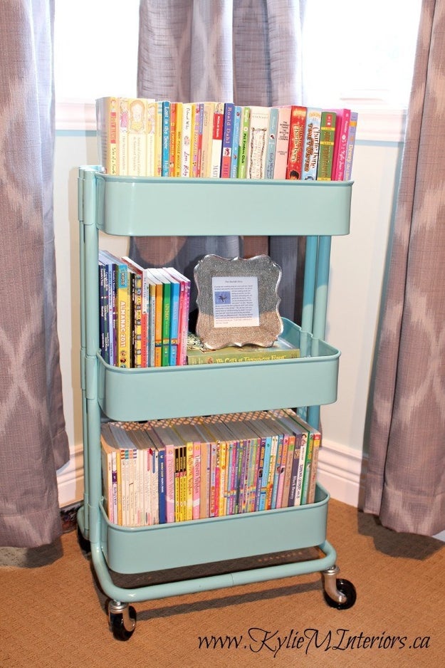 Enlist an inexpensive Ikea Raskog cart to contain children's books.