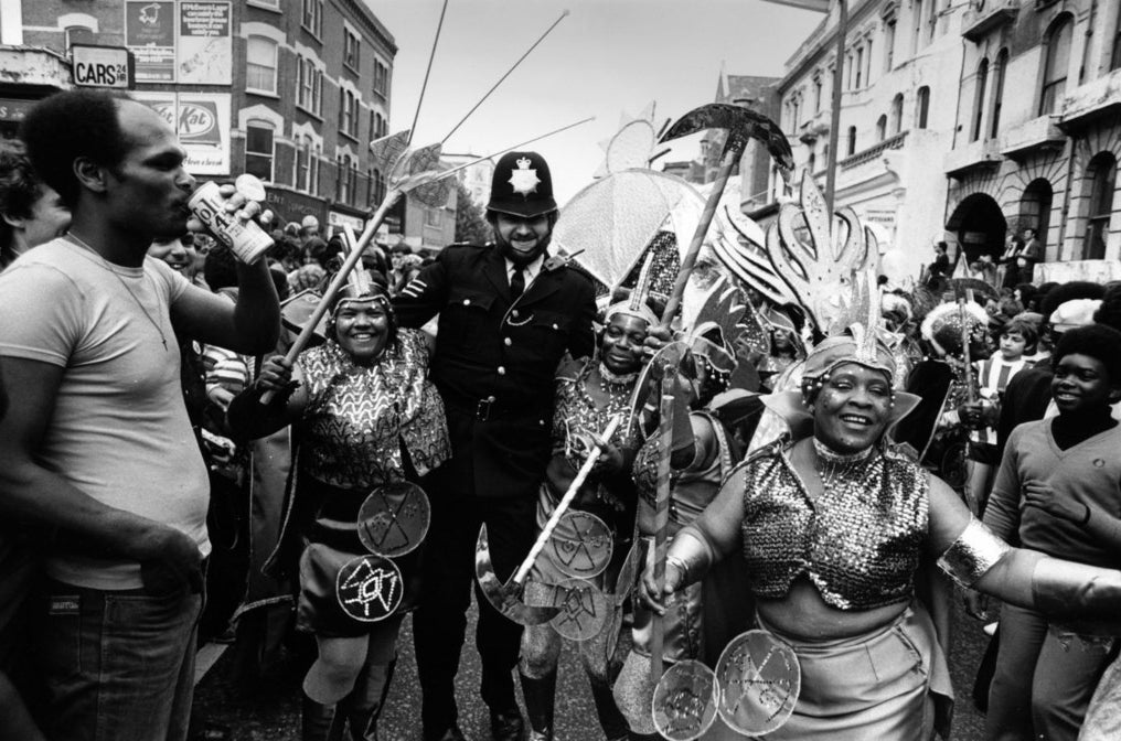 A policeman joins in with the festivities at the Notting Hill Carnival in west London, 1978.