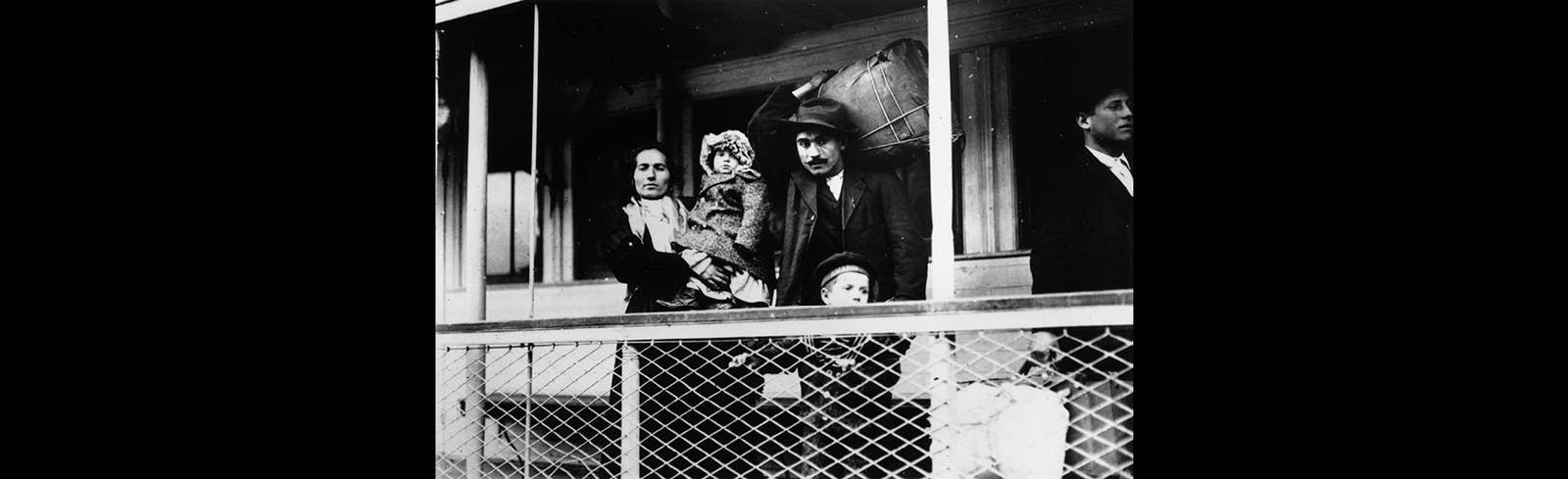 An Italian immigrant family on a ferry from the docks to Ellis Island, New York.