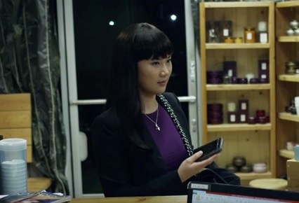 Look at her! Asian, brown black hair, straight bangs, almond shaped eyes with the slight upward slant, skin color, the whole thing. I looked at the video credits, found her IMDb page, and found her headshot photo, and looks almost identical to the Barbie doll. LOL. Her name is Elena Choo.