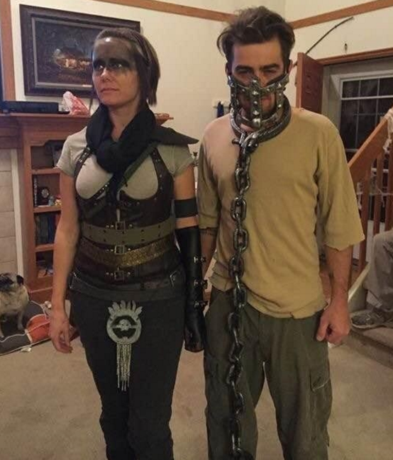 One person in a corset and one person with chains on his face