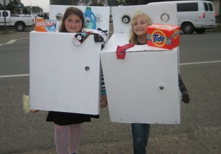 Two kids dressed as a washing and drying machine