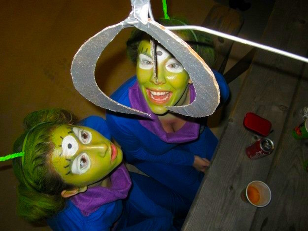 Two people with painted green faces