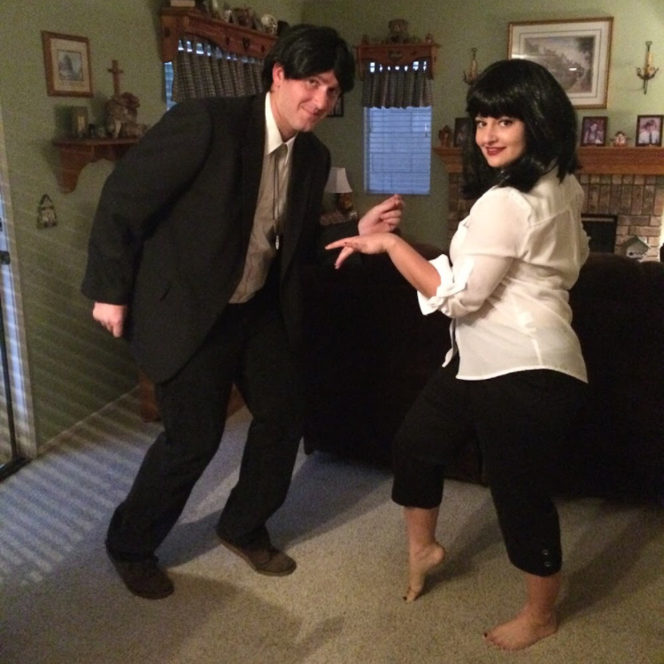 Man in a suit and a woman in a blouse and pants dancing