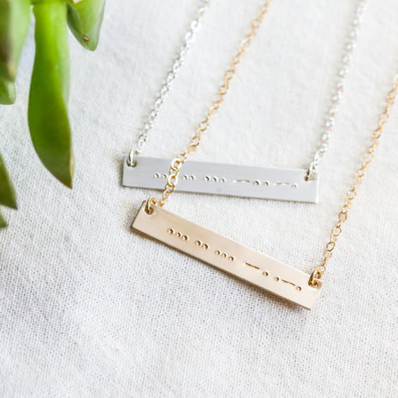 Matching necklaces for sisters who use a secret code.