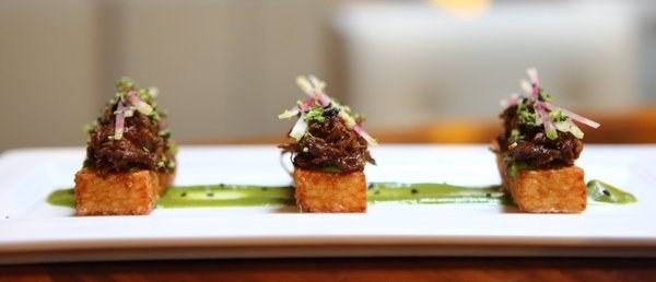 On top of crunchy, sticy rice cake is a generous portion of tender, braised short rib topped with cabbage slaw and complemented by broccoli puree