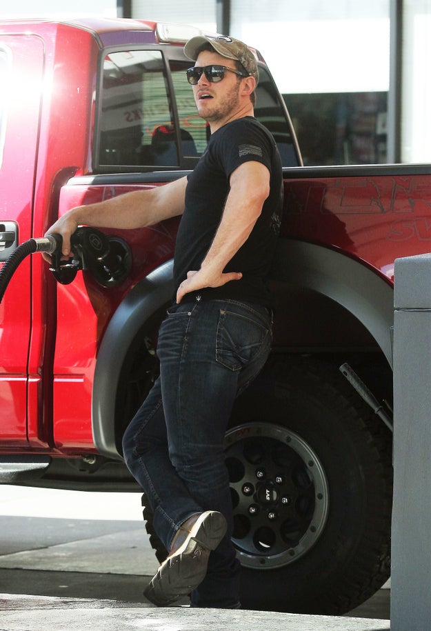 Chris Pratt was photographed looking 🔥 while getting gas for his big red truck because HE'S CHRIS PRATT: KING OF LOOKING HOT WHILE DOING THE MUNDANE.