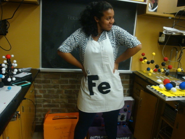 person wearing an apron that reads &quot;Fe&quot;