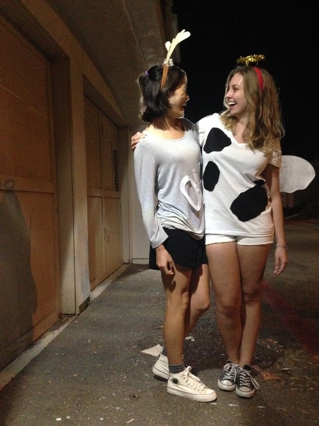 one girl dressed as an angel, one girl dressed as a cow