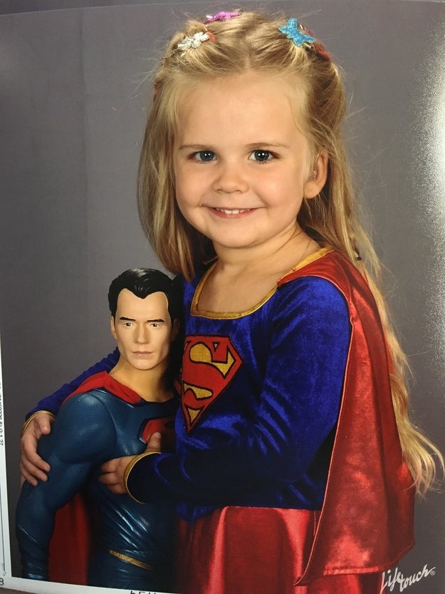 The result? This truly epic portrait, complete with adorable hair clips and a dashingly handsome Superman doll she's clutching ever so lovingly.