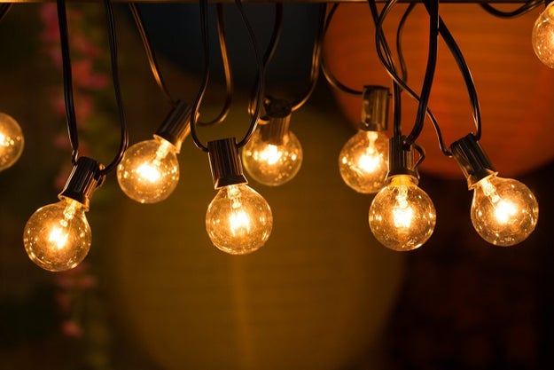 Skip decorations and criss-cross globe string lights across your ceiling to add some mood lighting.