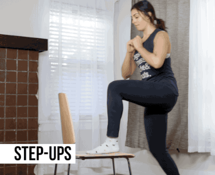 Carefully step into the center of the chair's seat with your right leg, and then bring your left knee into your chest. Repeat on the other side.
