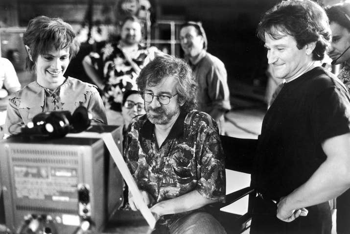 Julia Roberts and Robin Williams watch daily production footage with director Steven Spielberg on the set of Hook.