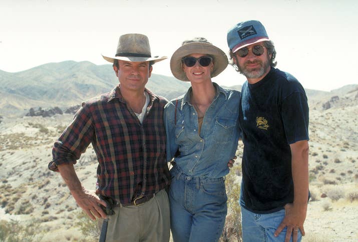 From left: actors Sam Neill and Laura Dern pose with director Steven Spielberg on the set of Jurassic Park.