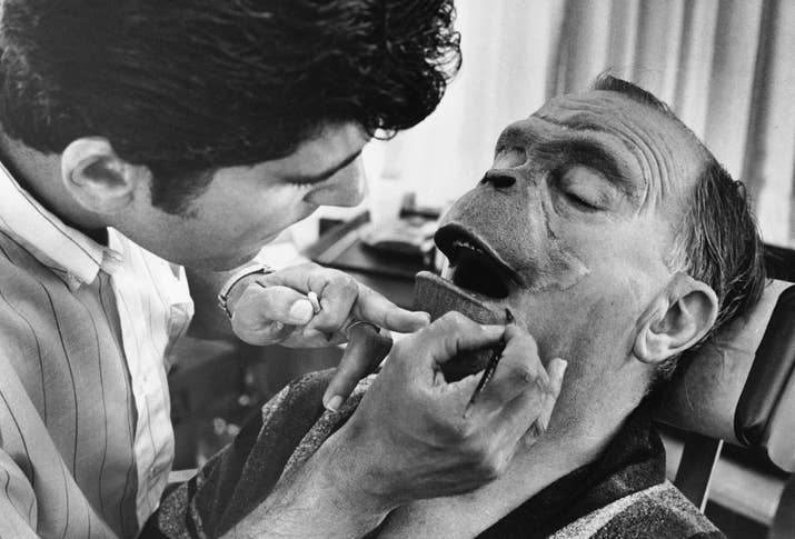 Foam-rubber makeup being applied to actor Maurice Evans.