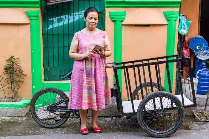Nurhaida Sirait-Go, a grandmother that speaks the native Batak language and uses Facebook on her smartphone to connect to friends and family, poses for a portrait.