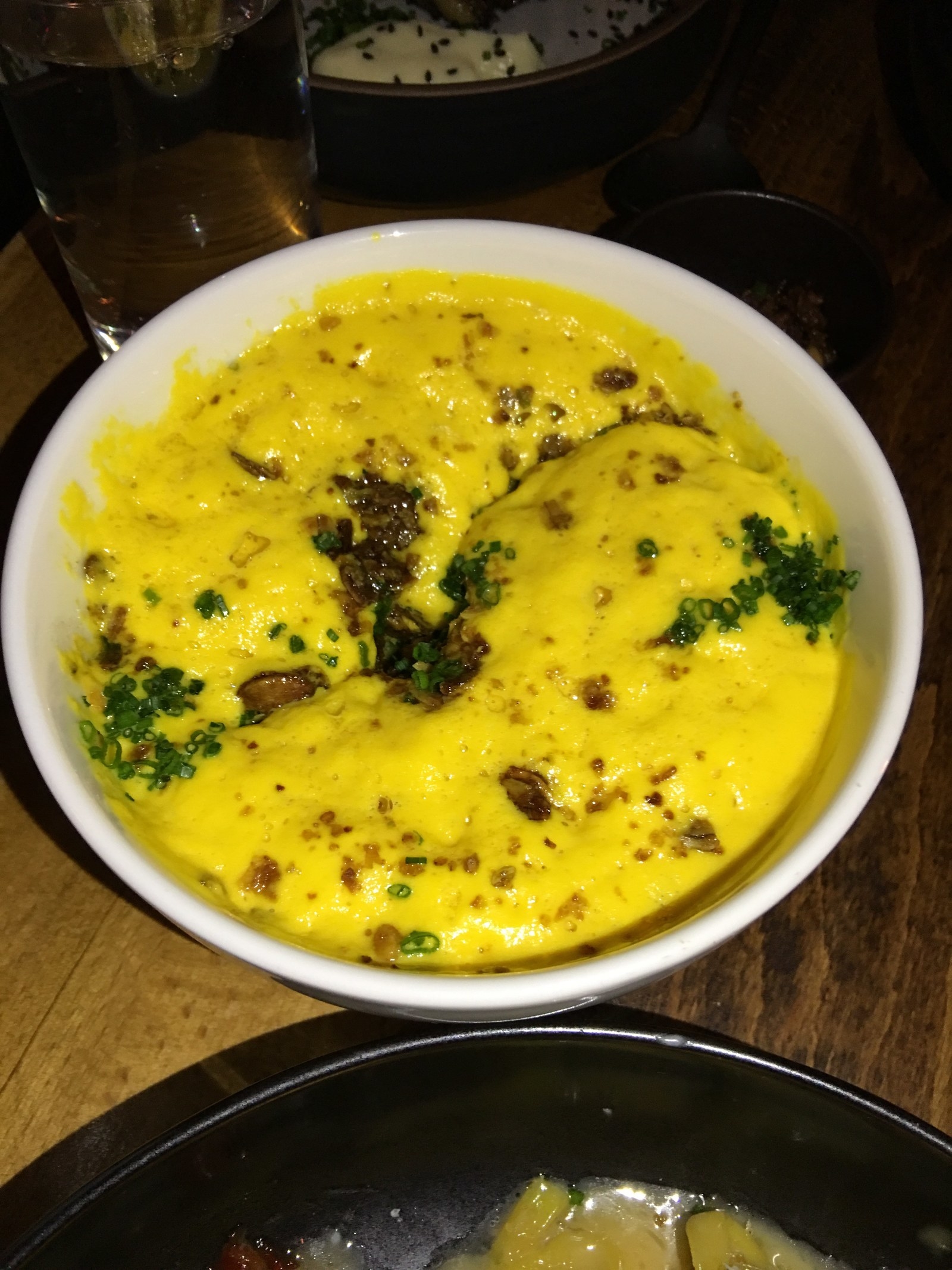 The fluffy, mashed kabocha squash has cloud-like texture. The squash is mixed in with crunchy and sweet vadouvan granola and chive.