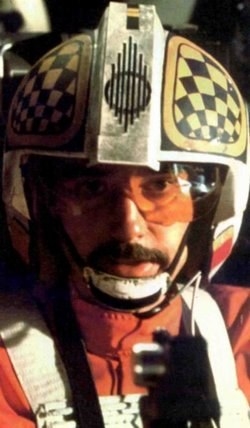 There is a connection with Sabine to A New Hope through the checkerboard pattern on her armor shoulder. It is identical to the checkerboard pattern painted on Big Darklighter’s Helmet at the Battle of Yavin. Though not officially in a canonical work this innocuous piece of art on Biggs' helmet was put there by Sabine before he perished at the Death Star. Pablo and Company said that was their intention in choosing the design for Sabine's armor. The plan was for her to eventually work with the Rebellion and pilots like Biggs. Which she did when she liberated Wedge Antilles and Derek "Hobbie" Klivian from the Imperial Tie Pilot Academy in Star Wars Rebels! Sabine was vital to the rebellion and she would not have sat out during the events of Rogue One.And I spotted her in RO with the same pattern on the helmet of a female Y-Wing pilot! In Rogue One's space battle, a female Y-Wing pilot with the checkerboard pattern helmet shouted to bomb the Star Destroyer orbiting the shield generator on Scarif.The RO pilot of the Y Wing calling for a torpedo run must be Sabine calling for the torpedo strike of the Star Destroyers in the Scarif Battle. The same checkerboard design appeared on both sides of the pilot's helmet. Aside from the trademark art the pilot was a bomber. Bombing is a perfect fit for Sabin'e background from Rebels in demolitions.Sabine's inclusion in RO enhanced Leia's character and her role in the Rebellion before she got caught taking out the white corvette by her father who probably did not approve of her explosive friend in armor. Leia, of course, would have reminded her Dad his best friend dressed exactly the same way too! Leia however did not need the example to rebel when she met the crew on Lothal. She had been rebelling a long time because....