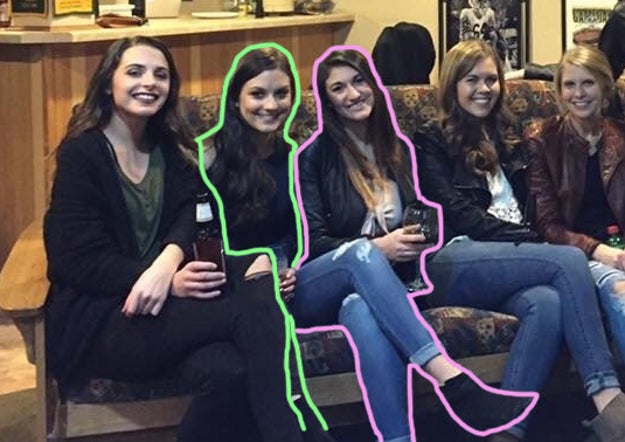 When you trace the two women in the middle the answer becomes apparent. The third woman with the wine glass has her body tilted toward the camera, which make it seem as if her legs belong to the woman to the left of her. The first two women also are wearing black jeans, which makes it seem like the second woman is wearing light blue jeans.