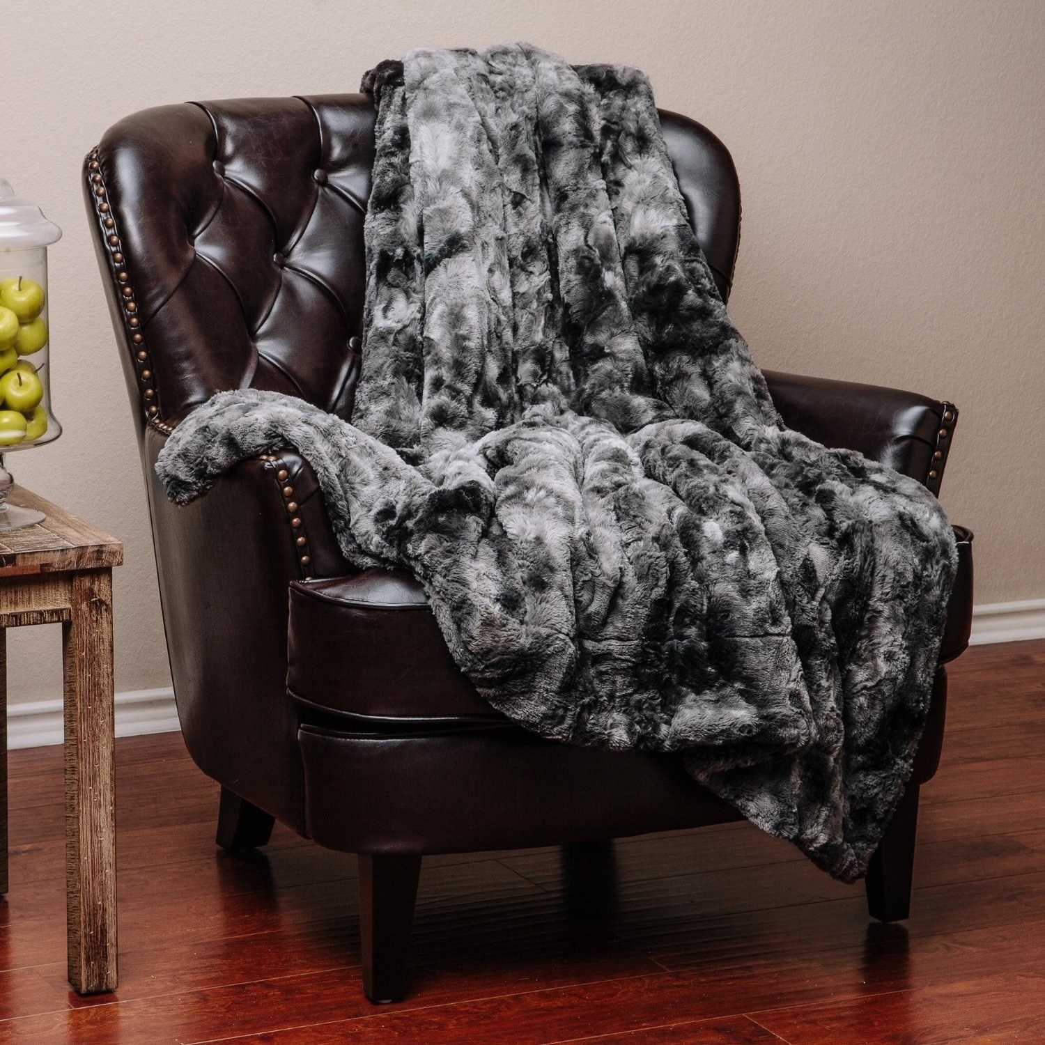 leather arm chair with faux fur gray blanket on it