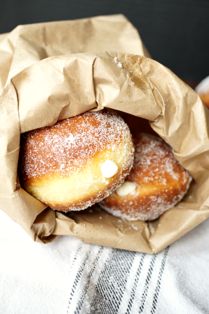 Brown bag filled with cream-filled bombolone