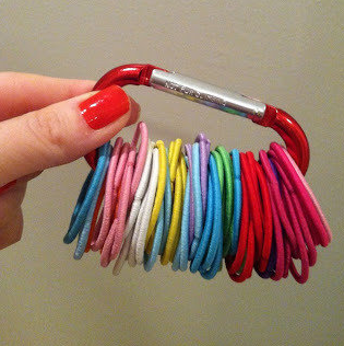 Use a carabiner to neatly store ponytail ties so they don't get scattered everywhere.