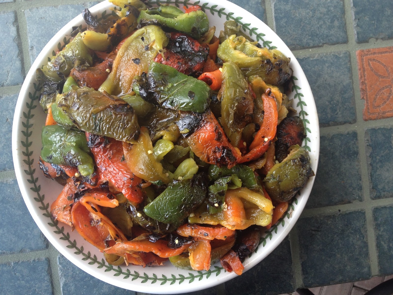 There’s nothing better than ember roasted sweet peppers in the outside fireplace or pit. Here’s what you’ll need:•An Outside fireplace or pit that is clean of ashes •Cast iron skillet, if you prefer to cook in a container rather than directly on the embers•Grande Sapore® Wood Chips from SmokinLicious® Gourmet Wood Products. •Sweet peppers- medium to large size, any color though multi colored ones provide for a better presentation, 10-18 quantityBUILDING THE FIRE My plan is to roast the peppers directly on the embers in my outdoor fireplace. So first, I need to clean out the fire box from any ash and debris. Then I select the hardwood for the actual cooking. I’m going to use Ash because it is one of the best hardwoods for producing evenly sized coals and heat level when it burns. While I am using pieces of the SmokinLicious wood chunks, the Grande Sapore® ash chips will produce the same great results. In fact, use of the Ash Wood Chips will likely save some time as their pre-ground state would allow for quicker coal build up due to their faster burn rate. Remember, the need with ember cooking is to ensure that you have a 2-3” buildup of coals so the cooking process is uninterrupted.THE EMBER BEDI now have a bed of coals establish in the bottom of the fire box. Spread them out to provide a wider cooking area and facilitate an even heat level. I will be increasing the depth of the coal bed over the course of my cook by maintaining a perimeter of newly lite wood product. I would suggest using Grande Sapore® SmokinLicious Gourmet Wood chips for the additions as the bed can be built up much quicker and keep the cooking process moving forward.ADDING THE PEPPERSOnce the Ash develops into a great bed of coals you’ll understand why I love to use Ash for ember cooking. The uniformity of the coal bed is so precise! Remember, Ash is part of the olive family of trees so it is known for its mild smoky flavor making it an ideal choice.I begin adding my peppers to the embers with the stem and seeds intact. It is so much easier to rid the peppers of its seeds once fully cooked so don’t be concerned about them now. I seat each pepper well into the hot coals to ensure that the base is enveloped in that consistent heat level. As the pepper begin the charring process, you’ll see them wrinkle a bit as this is the sign of the dehydration that takes place in this water rich vegetable.EMBER COOKING TECHNIQUE Once the pepper are in place, I allow them to cook and char before touching them. Once I see some char marks develop, I gently rotate each pepper around the coal bed, sliding over some new coals to the cooking area with each rotation. After about 20-25 minutes of ember roasting, the peppers will begin to tenderize. Remember there is a lot of moisture in sweet peppers so you may even hear them whistle a bit! Feel free to pierce them with a knife to release some water/steam. I like to do that step about ¾ of the way through the cooking process. I want to remind you that this ember cooking technique requires a tempered hand but also some attention throughout the cooking process. You will need to rotate the peppers frequently to ensure even char. Remember, our heat generation is developing from the bed of embers and then radiating to the walls of our cooking area as well as the food. Once removed from the heat source, the peppers will have wilted a bit as they enter an immediate change in temperature and humidity. THE FINISHING TOUCHOnce the peppers are completely charred and tenderized, remove them to a mesh or other tray to cool. Then you can use them in a variety of ways – cut into strips and drizzled with a lite coating of extra virgin olive oil, a hint of salt, fresh pepper and fresh mint. Or, use these beauties whole as a container for a ground turkey, beef, or lamb stuffing that includes fresh ricotta cheese, parsley, a hint of chili pepper flakes, and a topping of fresh mozzarella. The recipe options are endless so start experimenting or look to your favorite cookbook for inspiration!Bon Bar B QueDr Smoke