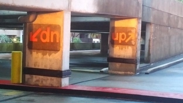 This car park that just bought a load of the same signs, and flipped them depending on their need.