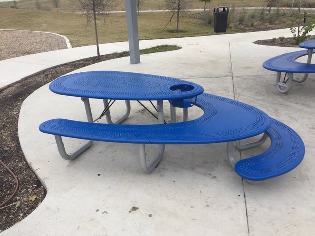 This picnic bench that has seating for small children, for adults, and a high chair.