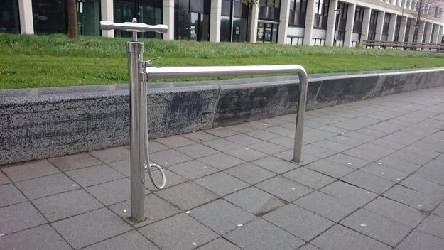 This bike stand that has a pump attached to it.