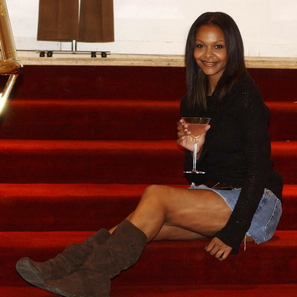 woman poses on stairs with baggy suede boots