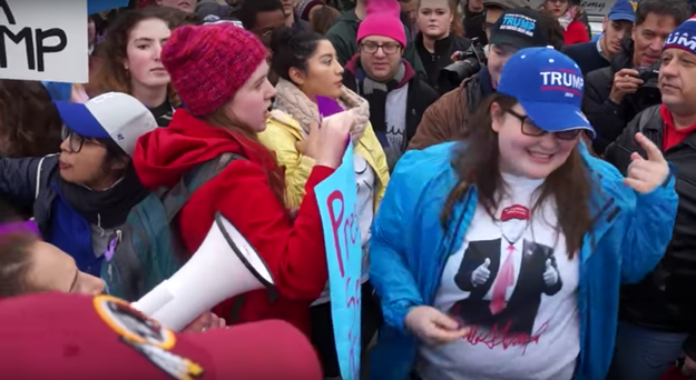 In the video, the girl — wearing a blue Trump hat and a Trump t-shirt — was seen posing for a photo in front of anti-Trump protesters.