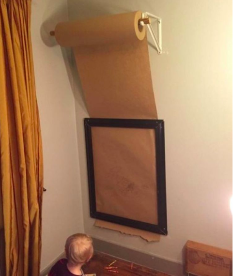Put a roll of butcher paper above a frame so your kid can draw a new masterpiece every day.